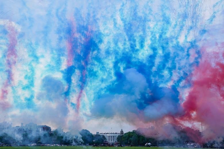 Red and blue smoke is fired at the Ellipse of the White House during the "Salute to America" event held to celebrate Fourth of July Independence Day in Washington. REUTERS/Sarah Silbiger  
